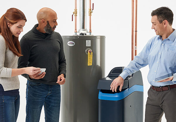 An EcoWater dealer showing a man and woman a water softener.